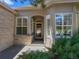 Inviting front entrance featuring detailed windows and a covered porch, creating a warm and welcoming entry point at 86 Woodland Cir, Highlands Ranch, CO 80126