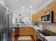 Modern kitchen boasts stainless steel appliances and wooden cabinets, offering a stylish and functional cooking space at 86 Woodland Cir, Highlands Ranch, CO 80126