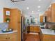 Open kitchen with stainless steel appliances and wooden cabinets offers a functional design for cooking and entertaining guests at 86 Woodland Cir, Highlands Ranch, CO 80126