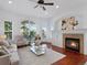 Bright living room boasts a fireplace, large windows, and a ceiling fan at 86 Woodland Cir, Highlands Ranch, CO 80126