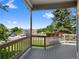 Deck overlooking parking area with greenery and flower planters on the wood railing at 86 Woodland Cir, Highlands Ranch, CO 80126