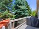 Patio with grill, mature trees, and beautiful landscaping, perfect for entertaining guests at 86 Woodland Cir, Highlands Ranch, CO 80126