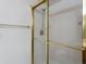 The standing shower has glass doors with gold trim and white tile interior at 86 Woodland Cir, Highlands Ranch, CO 80126