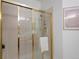 Glass shower with gold trim and tiled walls at 86 Woodland Cir, Highlands Ranch, CO 80126