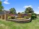 Community sign for Covent Ridge surrounded by colorful flowers and mature landscaping at 86 Woodland Cir, Highlands Ranch, CO 80126