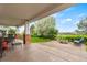 An outdoor area with fire pit, seating, lawn, and view of the backyard, golf course, and blue sky at 3075 Greensborough Dr, Highlands Ranch, CO 80129