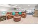 Finished basement featuring a large leather sectional sofa, stone fireplace, and exercise equipment at 3075 Greensborough Dr, Highlands Ranch, CO 80129