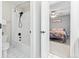 Clean bathroom with a tiled shower/tub combination, toilet, and doorway to the next bedroom at 3075 Greensborough Dr, Highlands Ranch, CO 80129