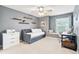 Cozy bedroom features neutral gray walls, floating shelves, and a comfortable daybed at 3075 Greensborough Dr, Highlands Ranch, CO 80129