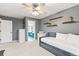 Stylish bedroom with gray walls, floating shelves, comfortable seating, and ensuite bathroom access at 3075 Greensborough Dr, Highlands Ranch, CO 80129