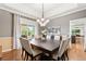 Spacious dining room features an elegant chandelier and a view of the backyard at 3075 Greensborough Dr, Highlands Ranch, CO 80129