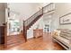 Grand foyer with hardwood floors, staircase, and views to the kitchen and living areas of the home at 3075 Greensborough Dr, Highlands Ranch, CO 80129