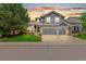 Charming two-story home with a manicured lawn and a three-car garage in a desirable neighborhood at 3075 Greensborough Dr, Highlands Ranch, CO 80129