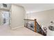 Upstairs hallway featuring an iron-rod banister overlooking the living room at 3075 Greensborough Dr, Highlands Ranch, CO 80129