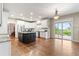 Large kitchen with granite countertops, white cabinets, stainless steel appliances and hardwood floors at 3075 Greensborough Dr, Highlands Ranch, CO 80129