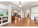 Open-concept living space features beautiful hardwood floors, a fireplace, and built in shelving at 3075 Greensborough Dr, Highlands Ranch, CO 80129