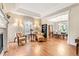 A sun-filled living room has a cozy seating area adjacent to the dining room at 3075 Greensborough Dr, Highlands Ranch, CO 80129
