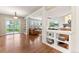 Sun-drenched open-concept living space with hardwood floors, a fireplace and access to outdoor patio at 3075 Greensborough Dr, Highlands Ranch, CO 80129