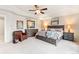 Spacious main bedroom features a ceiling fan, large windows and elegant decor at 3075 Greensborough Dr, Highlands Ranch, CO 80129