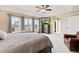 Spacious main bedroom features a ceiling fan, large windows and balcony access at 3075 Greensborough Dr, Highlands Ranch, CO 80129