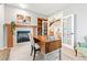 Bright office space features fireplace and french doors to staircase and living room at 3075 Greensborough Dr, Highlands Ranch, CO 80129