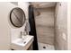 Modern bathroom featuring a contemporary sink, gray tile shower, and stylish fixtures at 7682 S Cove Cir, Centennial, CO 80122