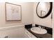Powder room features stylish granite counters, updated sink, and decorative wainscoting details at 7682 S Cove Cir, Centennial, CO 80122