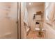 Bathroom featuring updated tile shower, and toilet with decorative wainscotting at 7682 S Cove Cir, Centennial, CO 80122