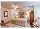 Inviting bedroom with a ceiling fan, an accent rug, and ample storage space with wooden furnishings at 7682 S Cove Cir, Centennial, CO 80122