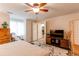 Comfortable bedroom featuring a neutral color palette, ceiling fan and closet leading to the bathroom at 7682 S Cove Cir, Centennial, CO 80122