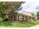 Charming home featuring a brick exterior, well-manicured lawn, mature trees, and a welcoming entrance at 7682 S Cove Cir, Centennial, CO 80122