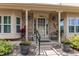 Welcoming front porch with brick accents, decorative plants, and seating, perfect for relaxing outdoors at 7682 S Cove Cir, Centennial, CO 80122