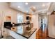 Stylish kitchen with dark wood floors, granite countertops, and modern appliances, offering a sleek design at 7682 S Cove Cir, Centennial, CO 80122