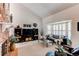 Inviting living room featuring a cozy fireplace, large windows with shutters, and stylish decor at 7682 S Cove Cir, Centennial, CO 80122