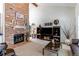 Bright living room showcasing a brick fireplace, modern furnishings, and vaulted ceilings at 7682 S Cove Cir, Centennial, CO 80122