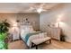 Spacious main bedroom featuring a ceiling fan, sitting area, and ensuite bathroom access at 7682 S Cove Cir, Centennial, CO 80122