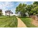 Community park features walking path, mature trees, lush green grass, and serene surroundings at 7682 S Cove Cir, Centennial, CO 80122