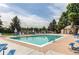 Community pool featuring sun loungers, tables, and surrounded by mature trees, perfect for relaxation and recreation at 7682 S Cove Cir, Centennial, CO 80122