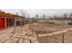 Large fenced backyard with stone patio, pergola, and greenhouse at 13200 E 160Th Ave, Brighton, CO 80602