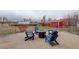 Well-maintained backyard with a fire pit, Adirondack chairs, and garden beds for outdoor enjoyment at 13200 E 160Th Ave, Brighton, CO 80602