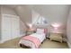 Bright bedroom features angled window, carpet, twin bed, and matching nightstands at 13200 E 160Th Ave, Brighton, CO 80602