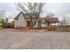 Charming home boasts unique architecture, beautiful landscaping, and an inviting gravel driveway at 13200 E 160Th Ave, Brighton, CO 80602