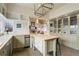 Bright kitchen features a butcher block island and glass-front cabinets at 13200 E 160Th Ave, Brighton, CO 80602