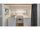 Bright laundry room with white washer, dryer, sink, and built in shelf at 13200 E 160Th Ave, Brighton, CO 80602