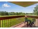 Outdoor balcony features iron table and chairs and serene neighborhood views at 12565 Sheridan Blvd # 105, Broomfield, CO 80020
