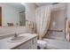 Well-lit bathroom with a tiled shower and tub combination and a neutral color scheme at 12565 Sheridan Blvd # 105, Broomfield, CO 80020
