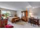 Spacious bedroom with a large window, plush carpeting, and an antique armoire at 12565 Sheridan Blvd # 105, Broomfield, CO 80020