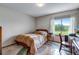 Cozy bedroom with a large window, carpeted floor and simple décor at 12565 Sheridan Blvd # 105, Broomfield, CO 80020