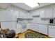 Bright kitchen with white cabinets, white appliances, and light countertops at 12565 Sheridan Blvd # 105, Broomfield, CO 80020