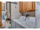 Well-lit laundry room with a washer, dryer, storage cabinets, and utility sink at 12565 Sheridan Blvd # 105, Broomfield, CO 80020